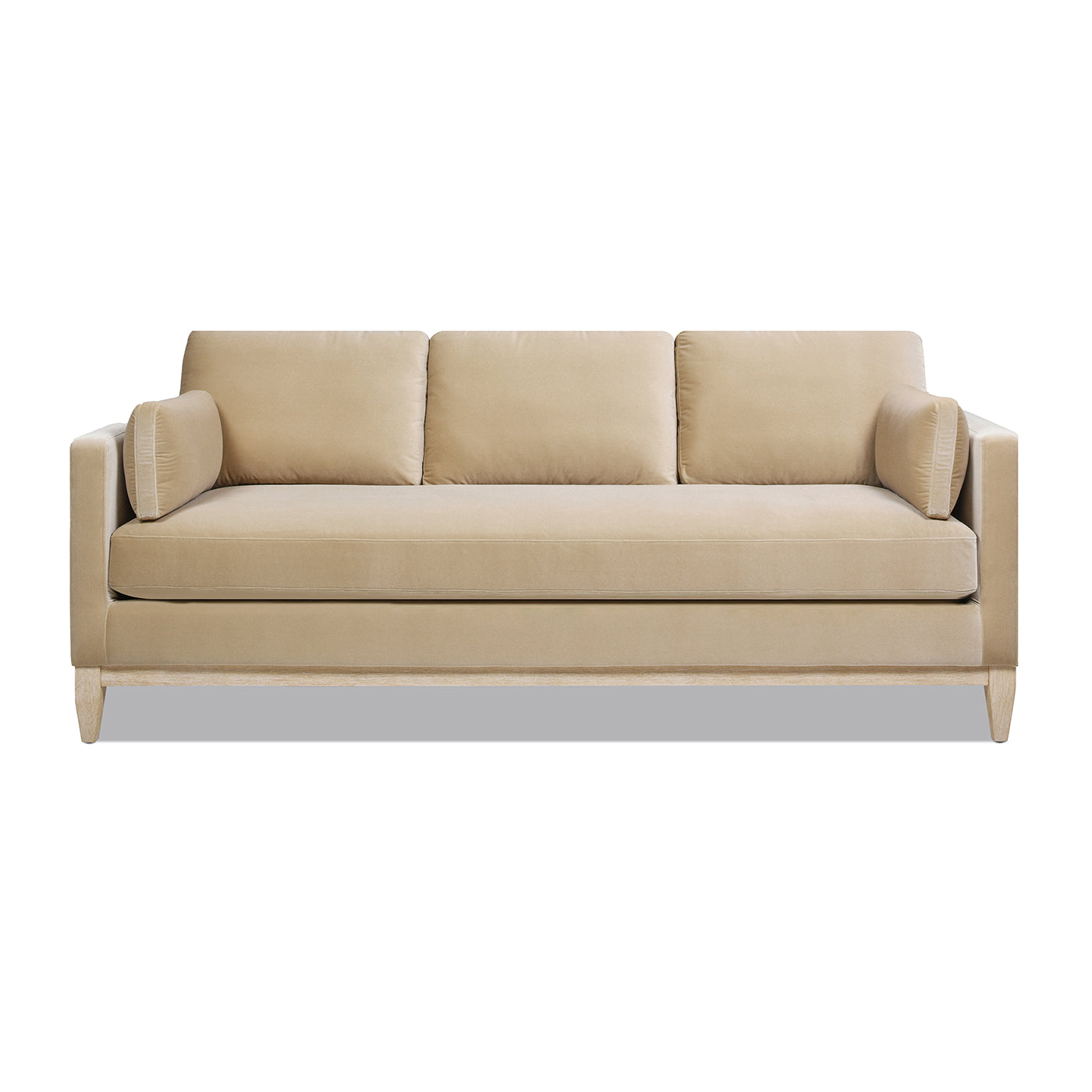 Beige velvet threeseater sofa with plush cushions and modern wood legs