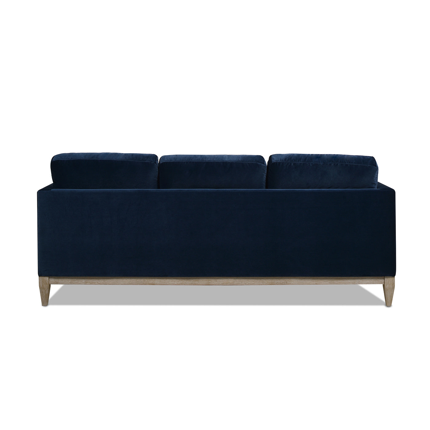 Navy blue velvet sofa with plush cushions and light wood legs