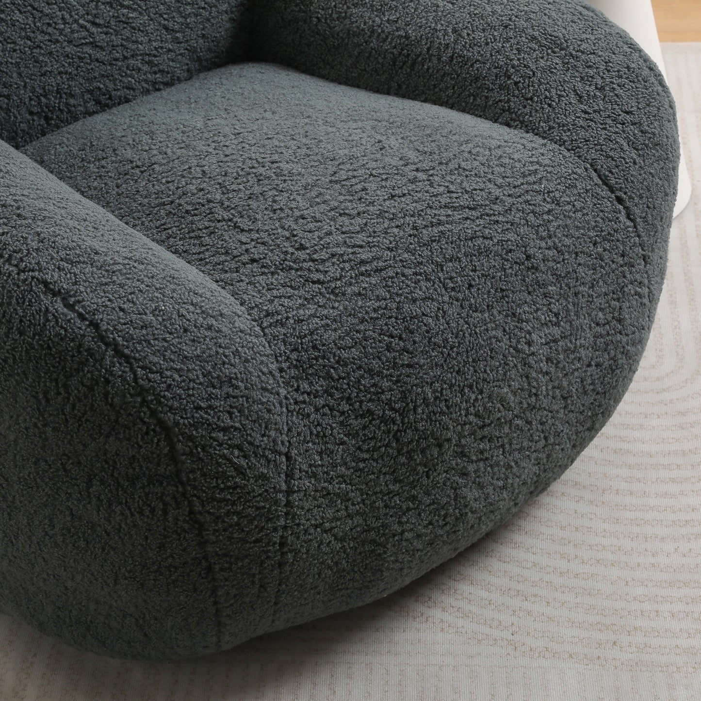 Plush dark grey teddy bear fabric armchair seat closeup