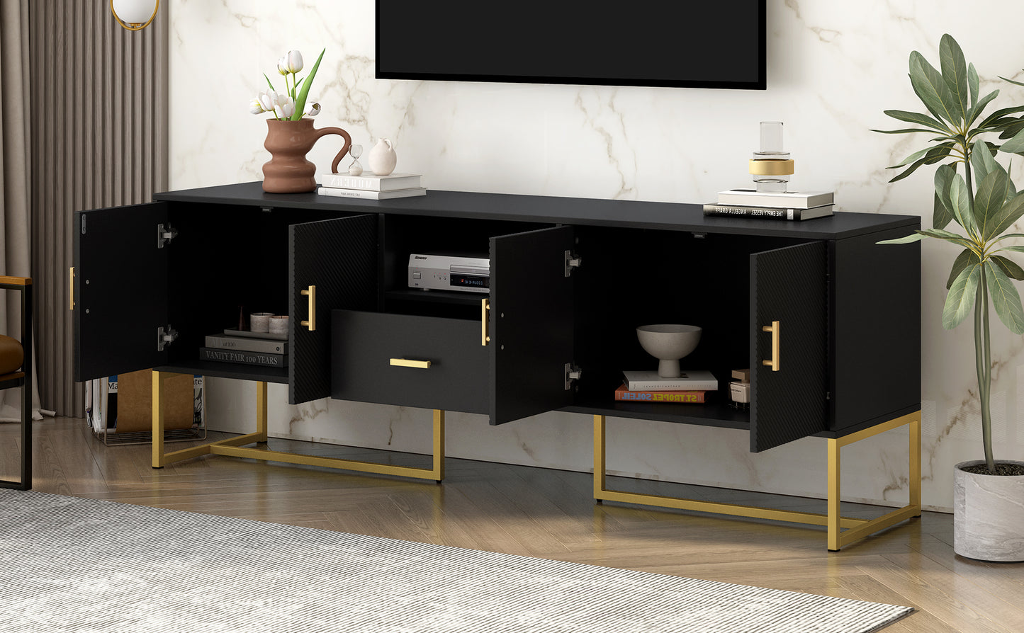 Black media console with gold legs and fluted doors