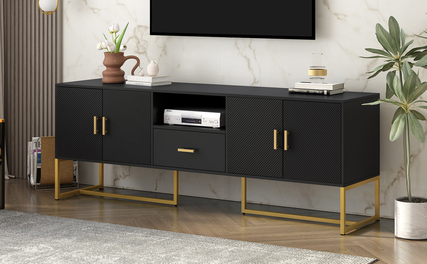 Black modern media console with gold legs and textured doors