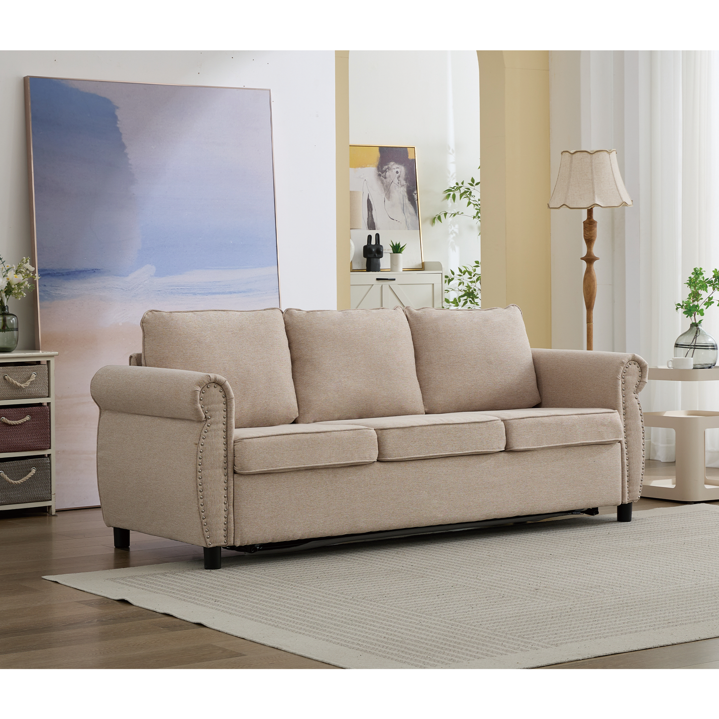Beige linen sofa with nailhead trim accents and plush cushions