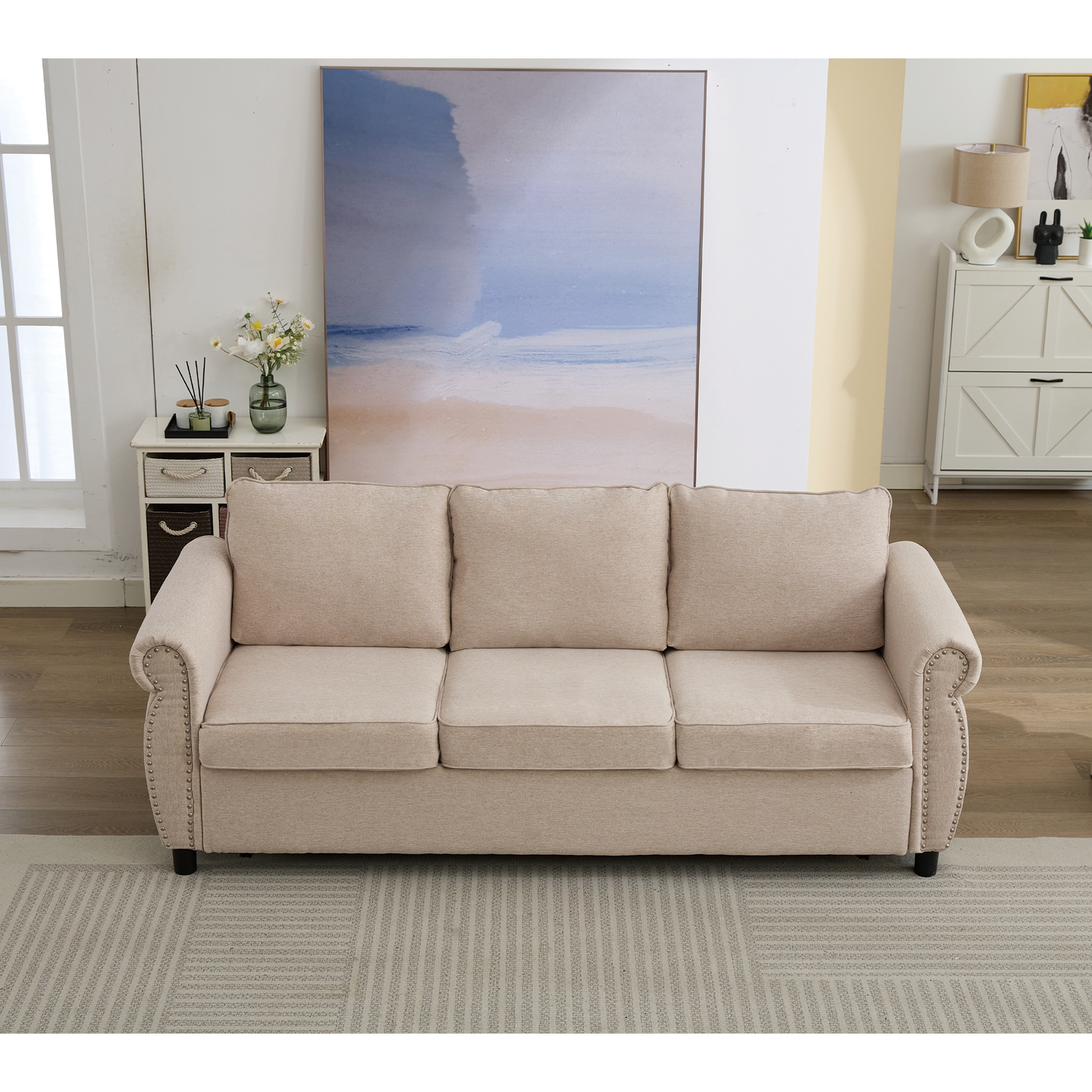 Beige upholstered seater sofa with nailhead trim