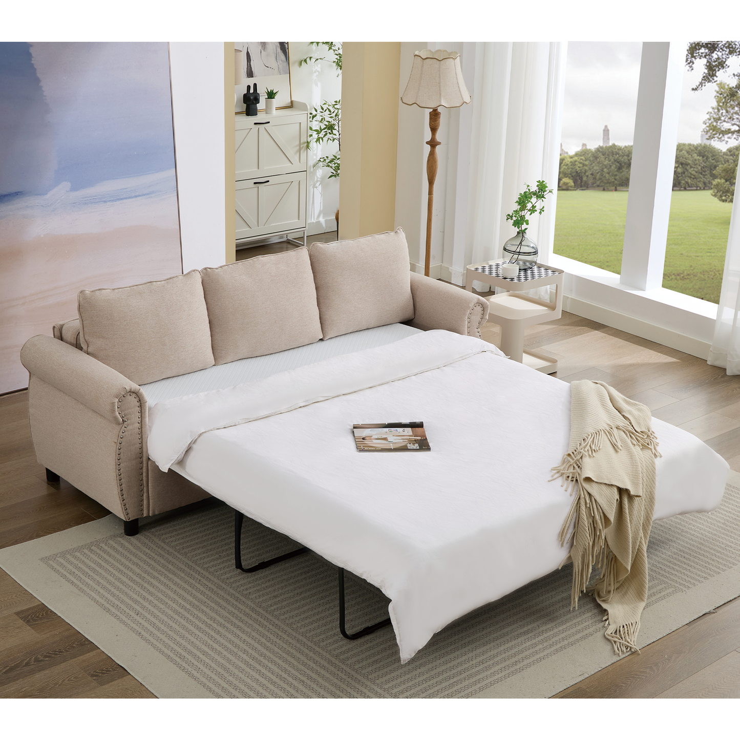 Beige fabric sofa bed with nailhead trim