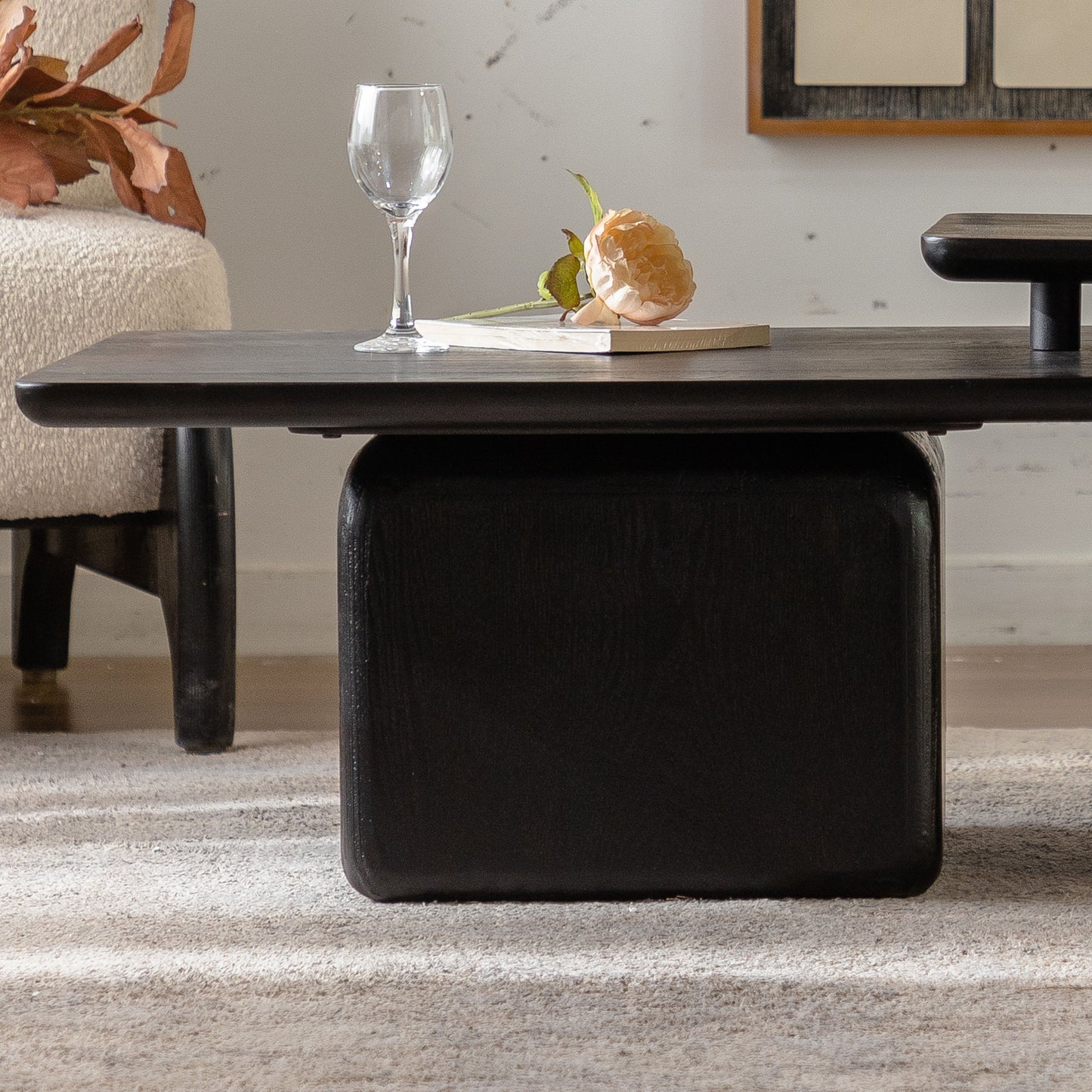 Black wooden coffee table with rounded edges and storage compartment