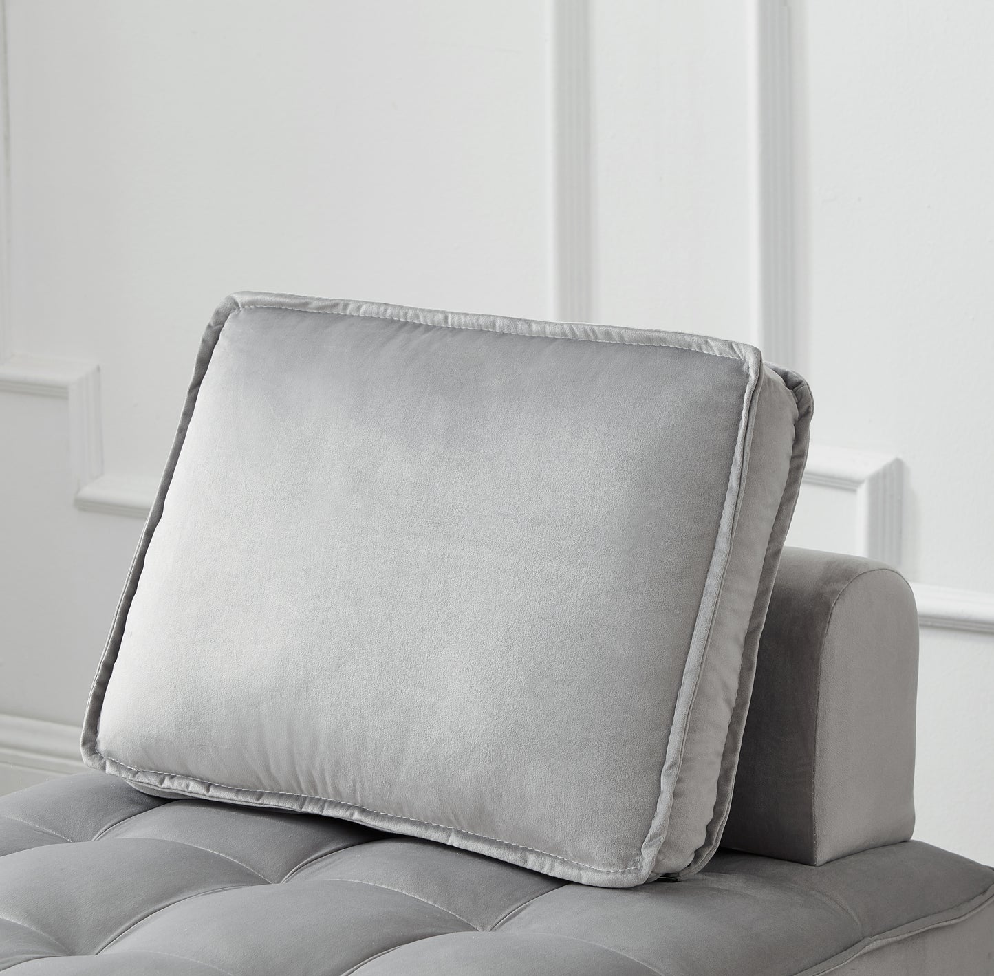 Plush grey velvet throw pillow with detailed stitching and piping