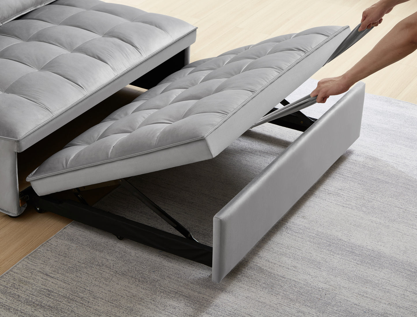 Grey velvet sofa bed with pullout mattress mechanism