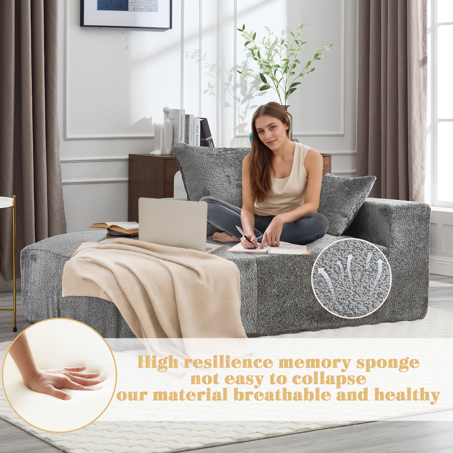 Plush gray sectional sofa with a beige throw blanket and a woman working on a laptop