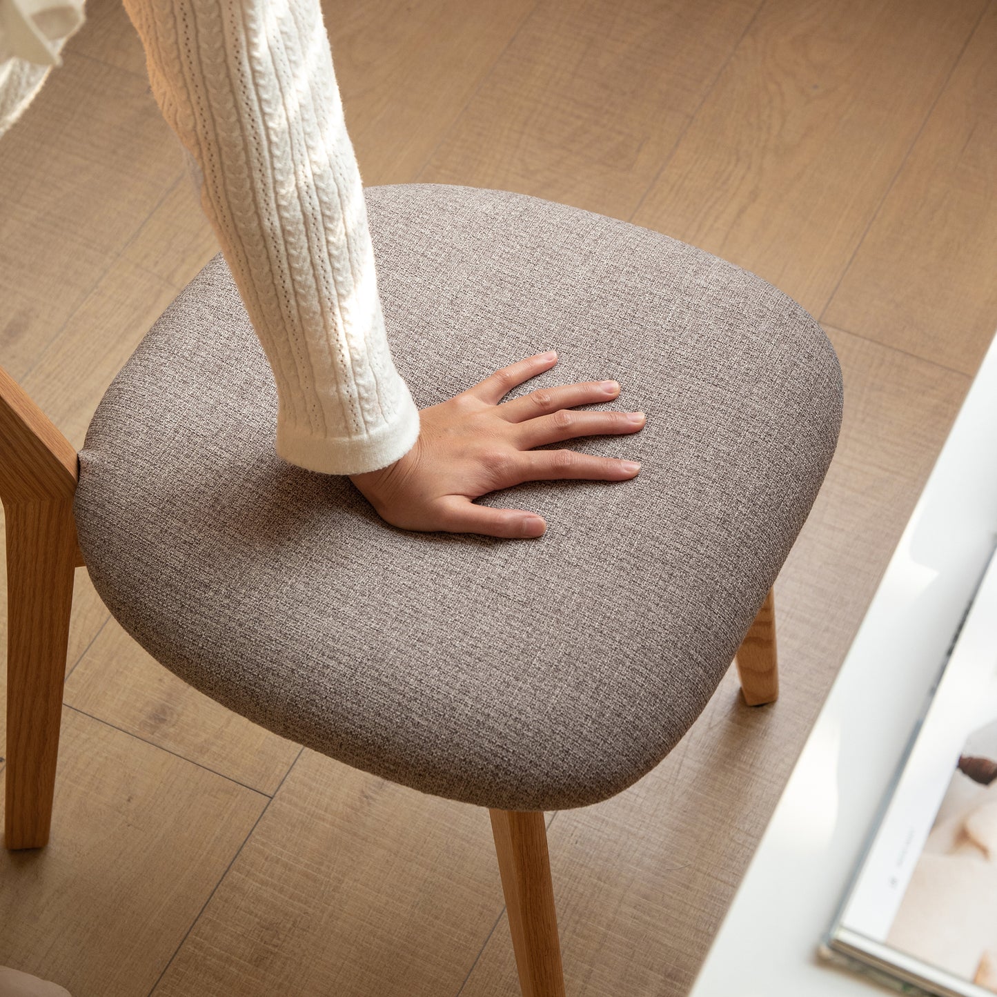 Textured grey fabric dining chair with natural wood legs