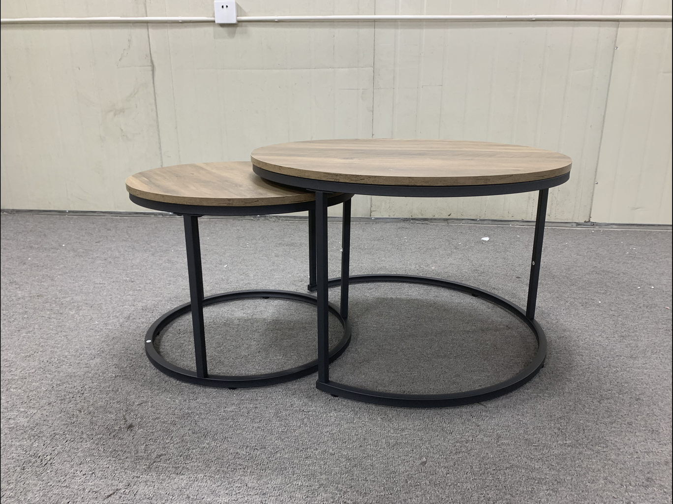 Round nesting coffee tables with oakeffect wood tops and black metal frames
