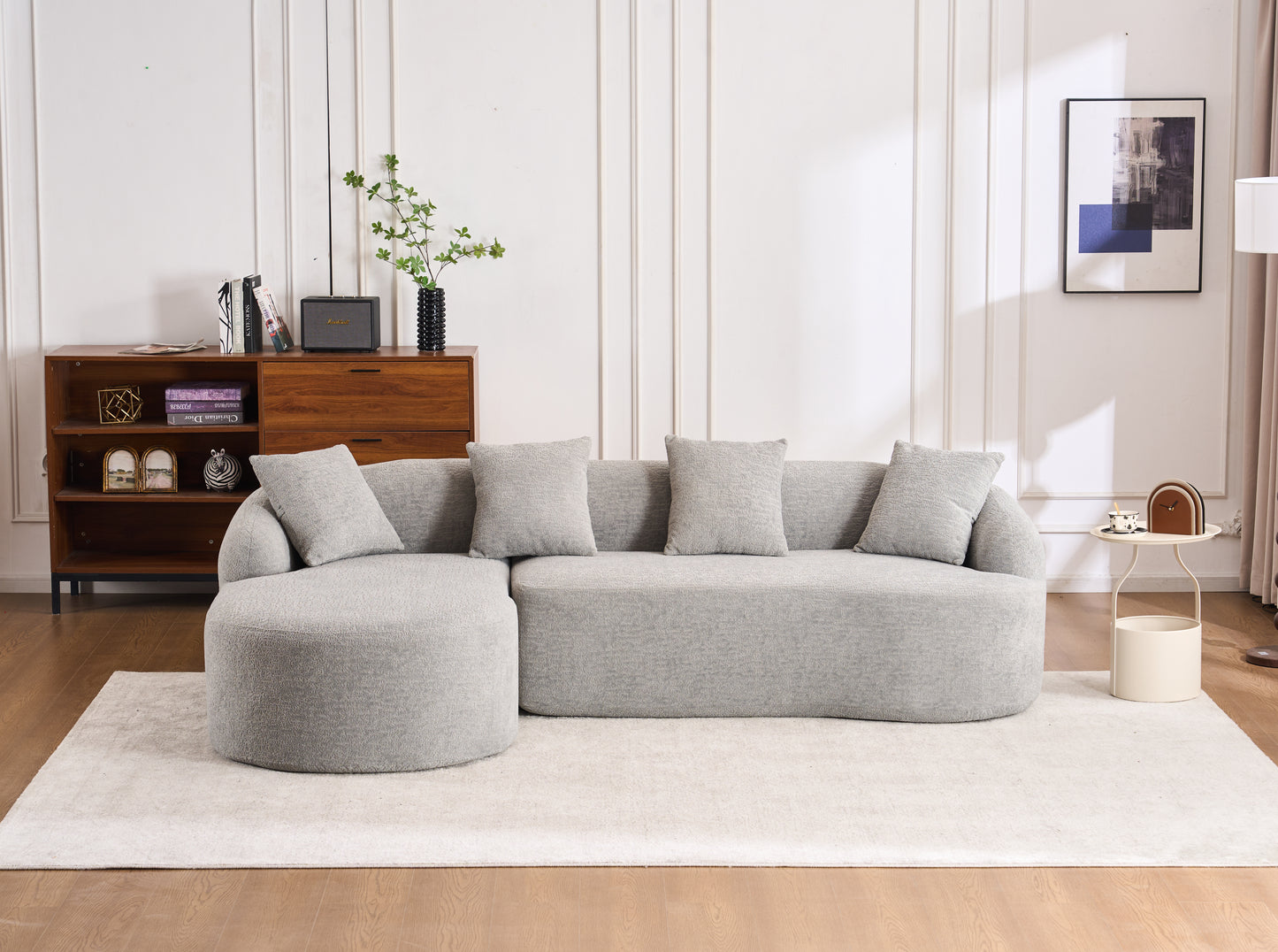 Grey textured fabric sectional sofa with rounded arms and plush pillows