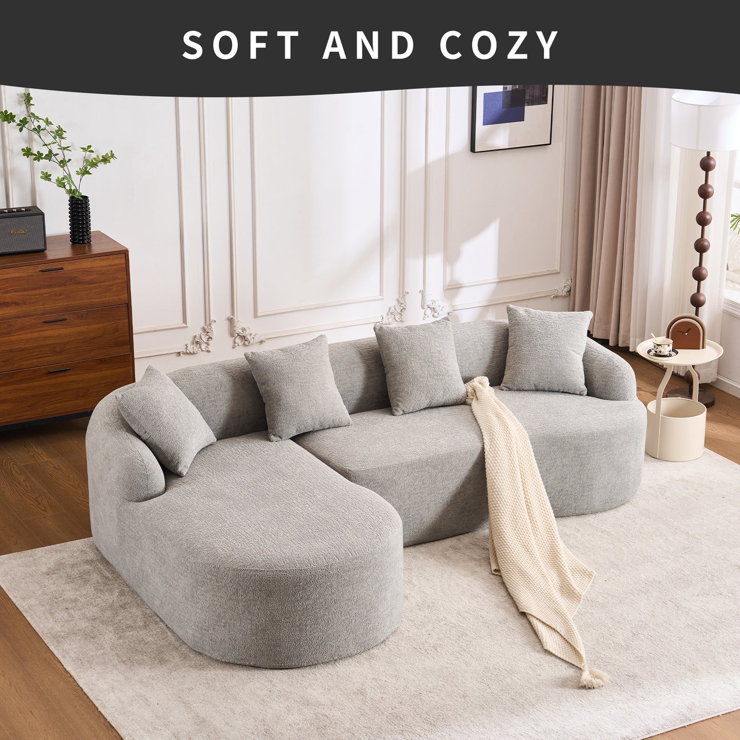 Plush grey sectional sofa with soft boucle upholstery and decorative pillows for a cozy living room setup