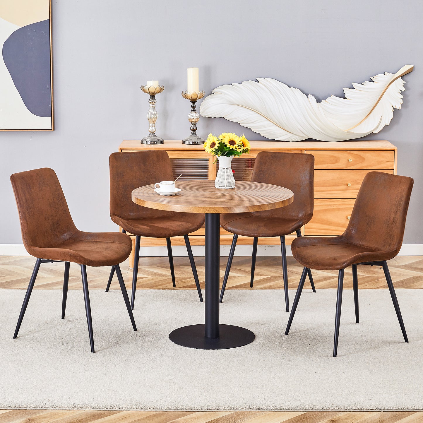 Brown upholstered dining chairs with black metal legs around a round wood table