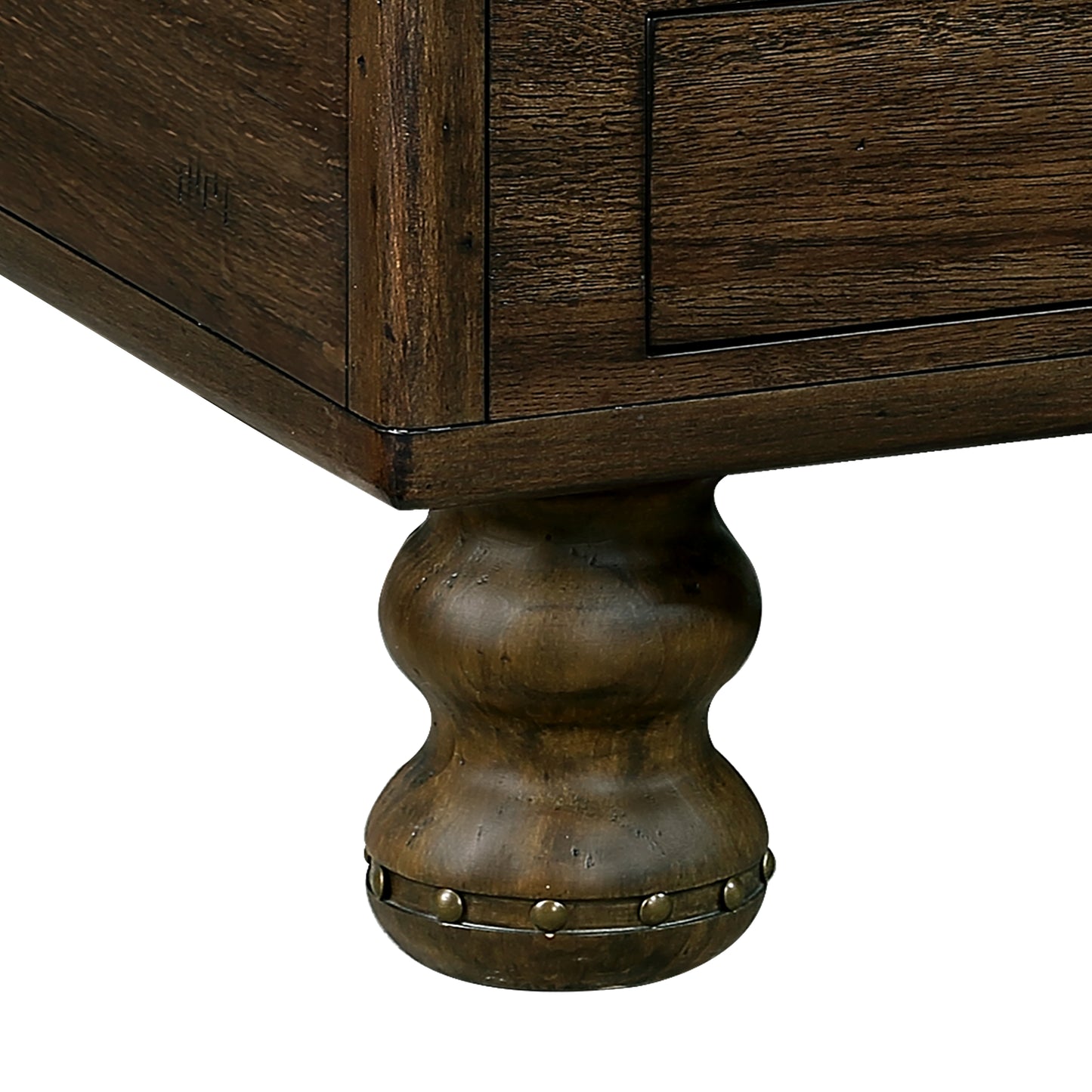 Ornate dark wood dresser leg with antique brass studs