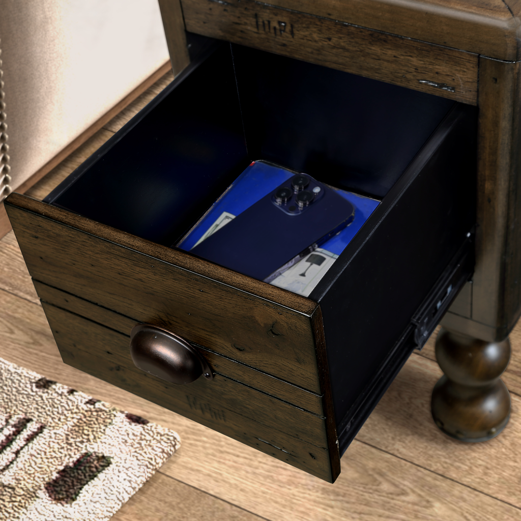 Rustic wooden nightstand with open drawer revealing a dark blue phone case and notebook