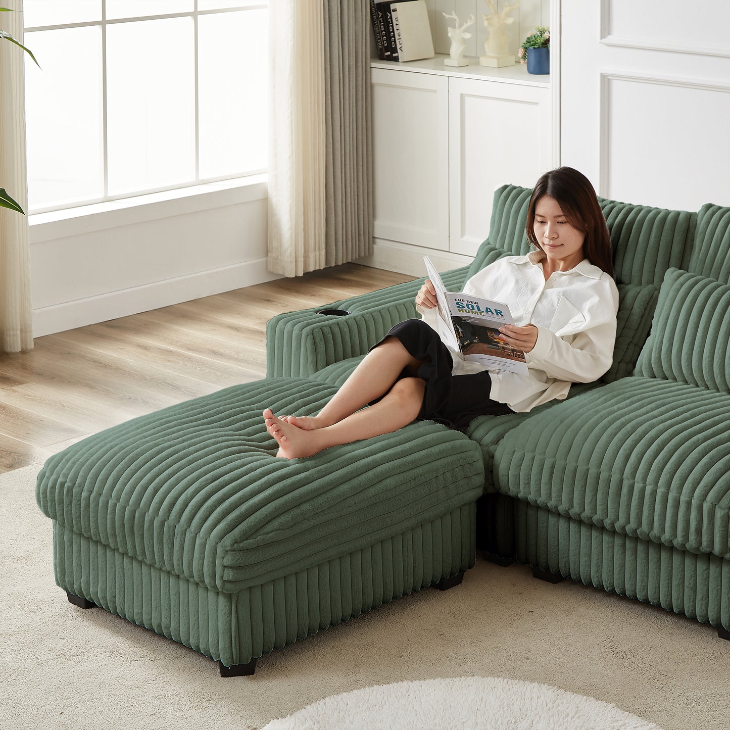 Green corduroy sectional sofa with chaise lounge and builtin cup holder