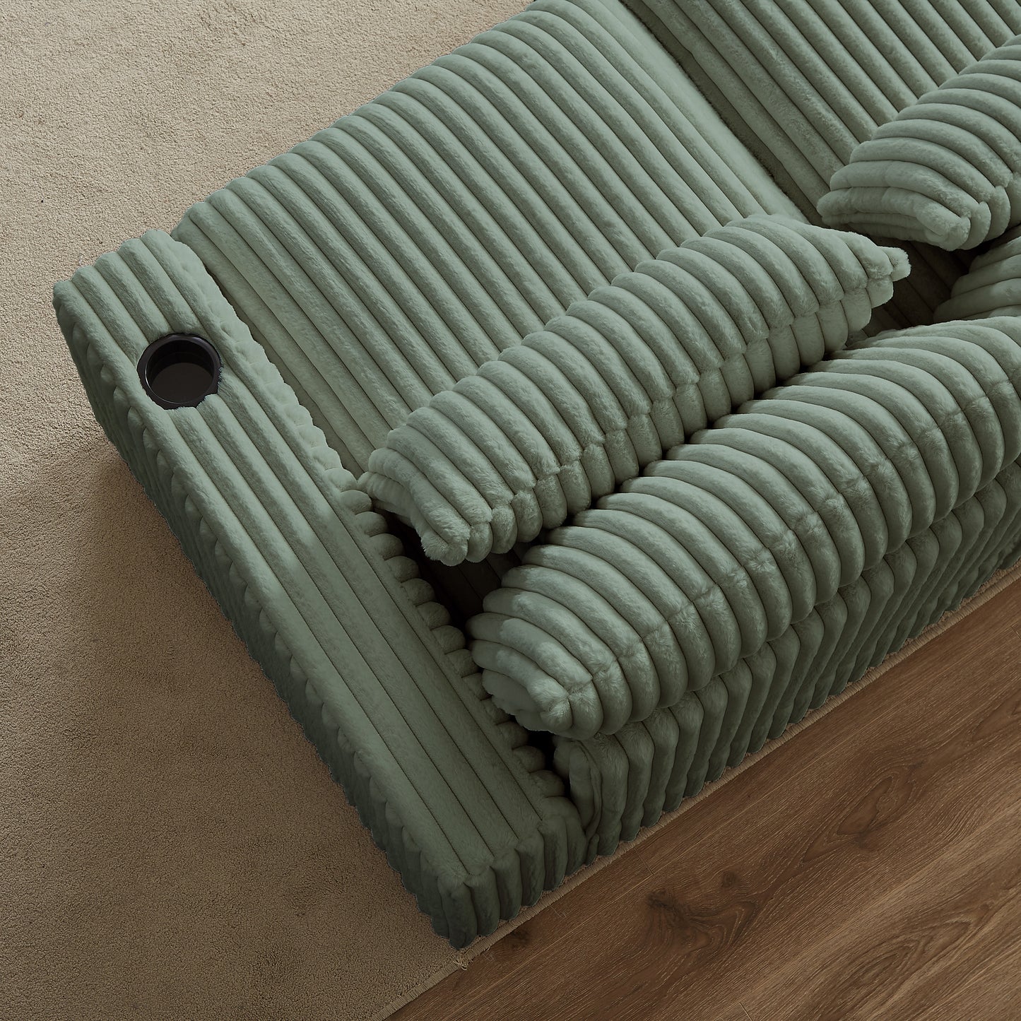 Sage green corduroy sofa with plush cushions and builtin cup holder