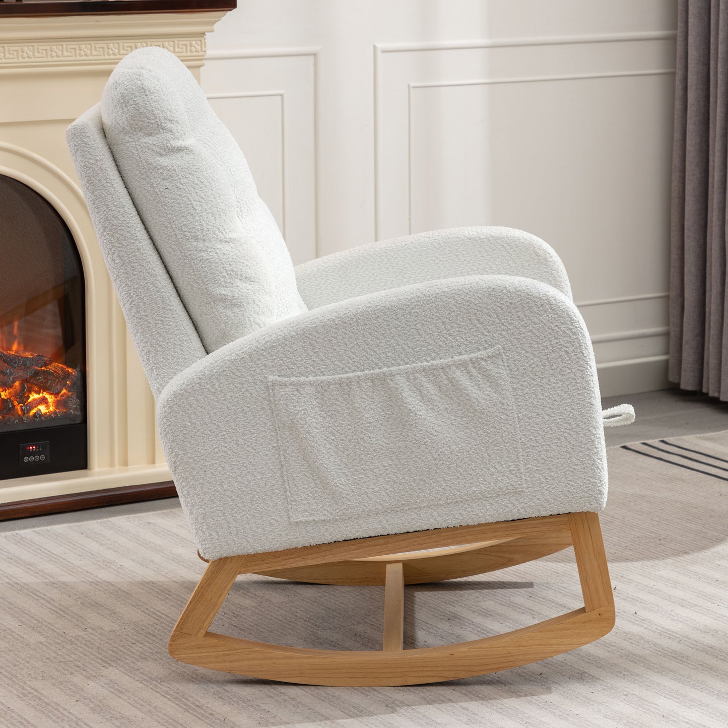 White boucle fabric rocking chair with wooden base and side pocket