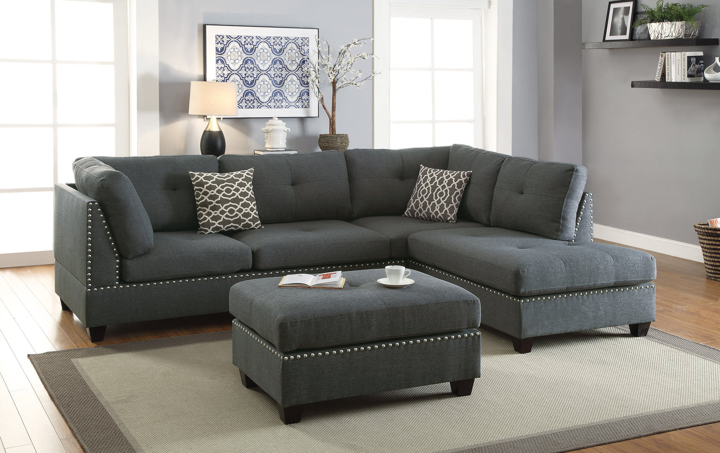 Dark gray fabric sectional sofa with tufted cushions and silver nailhead trim perfect for modern living rooms