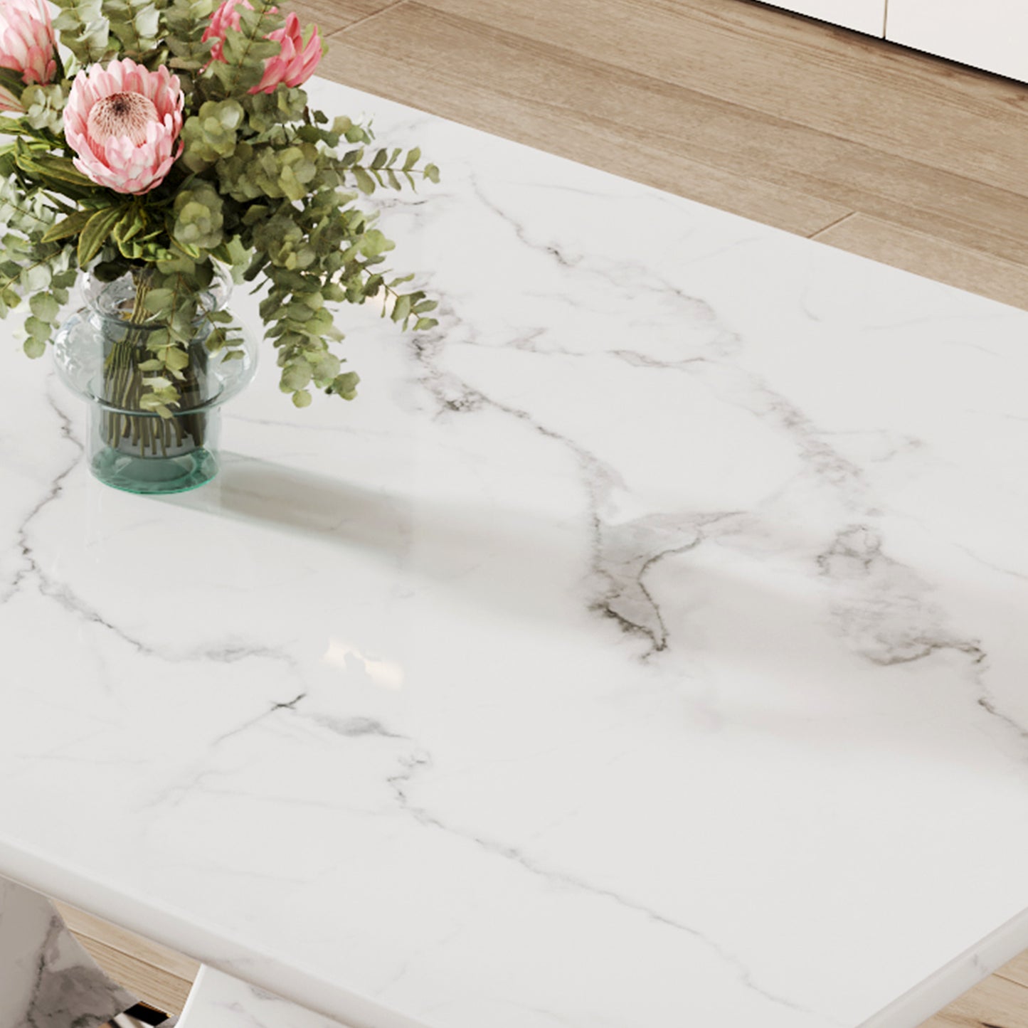 White marble coffee table with pink protea bouquet in glass vase