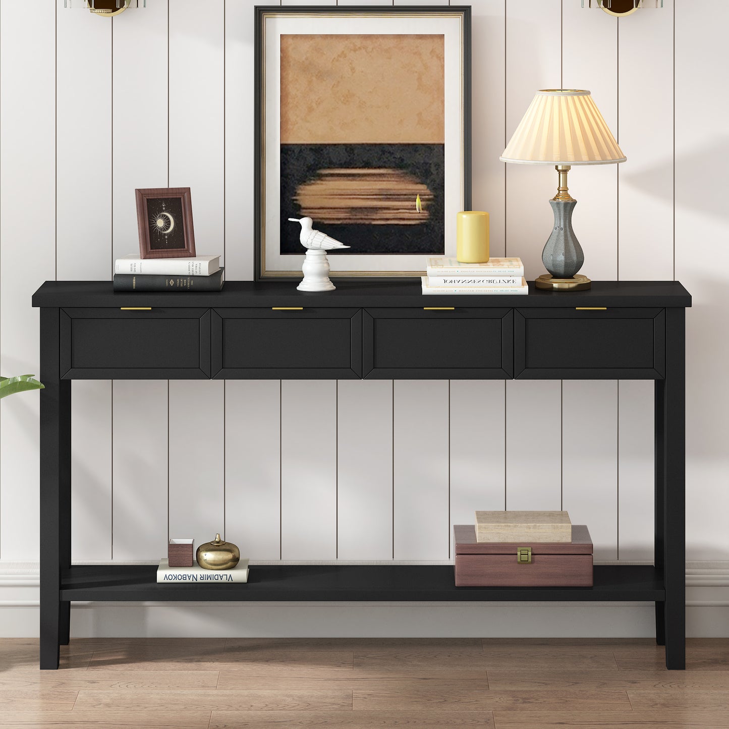 Black console table with four drawers and gold handles