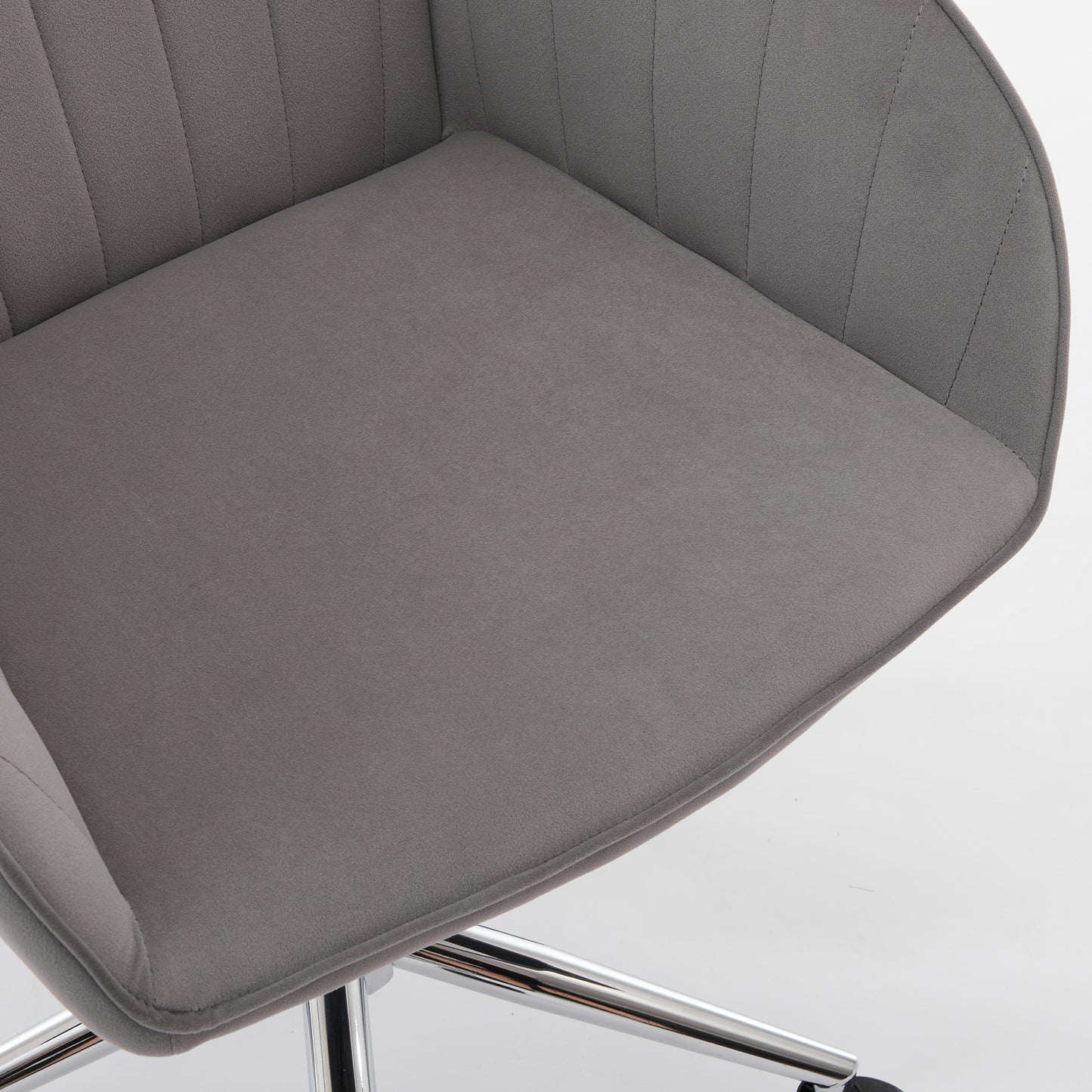 Grey velvet accent chair with tufted back and padded seat for home office