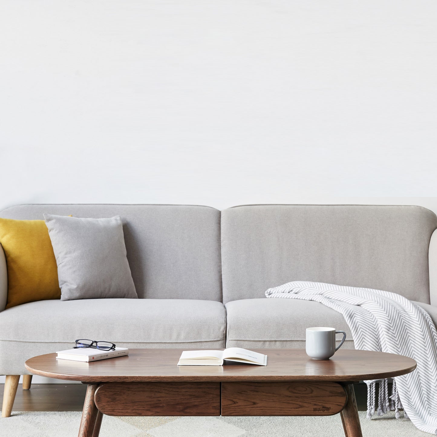 Grey linen sofa with mustard and light grey accent pillows