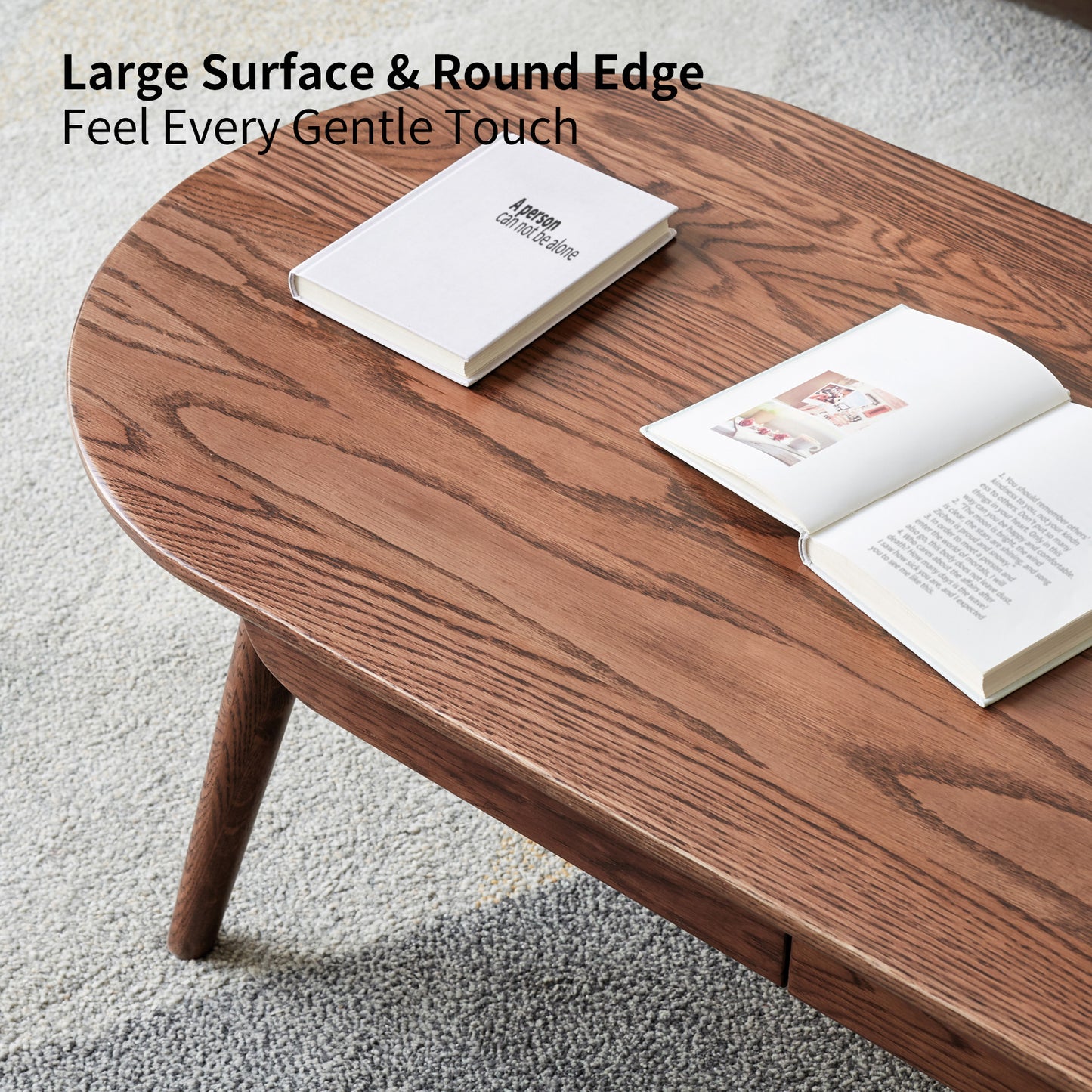 Brown wood coffee table with natural grain and rounded edges features a book