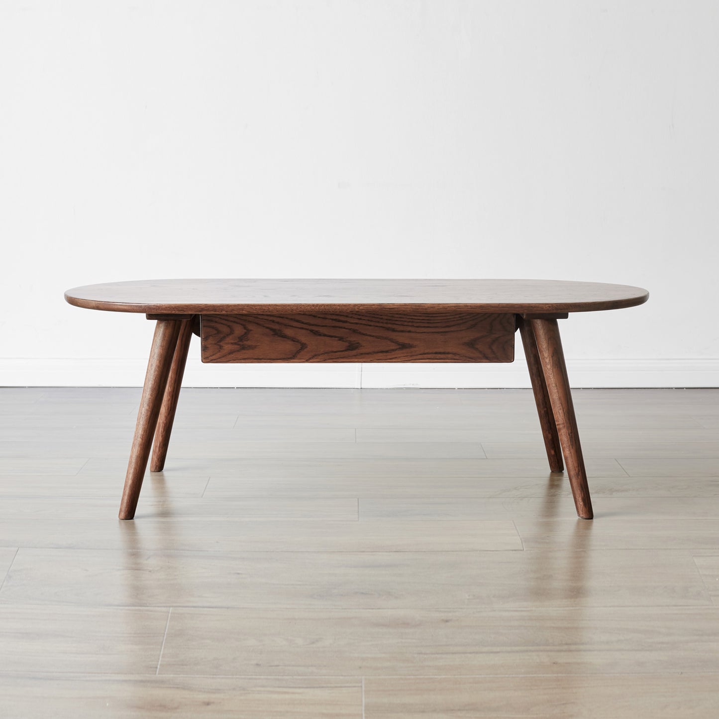 Dark wood oval coffee table with drawer