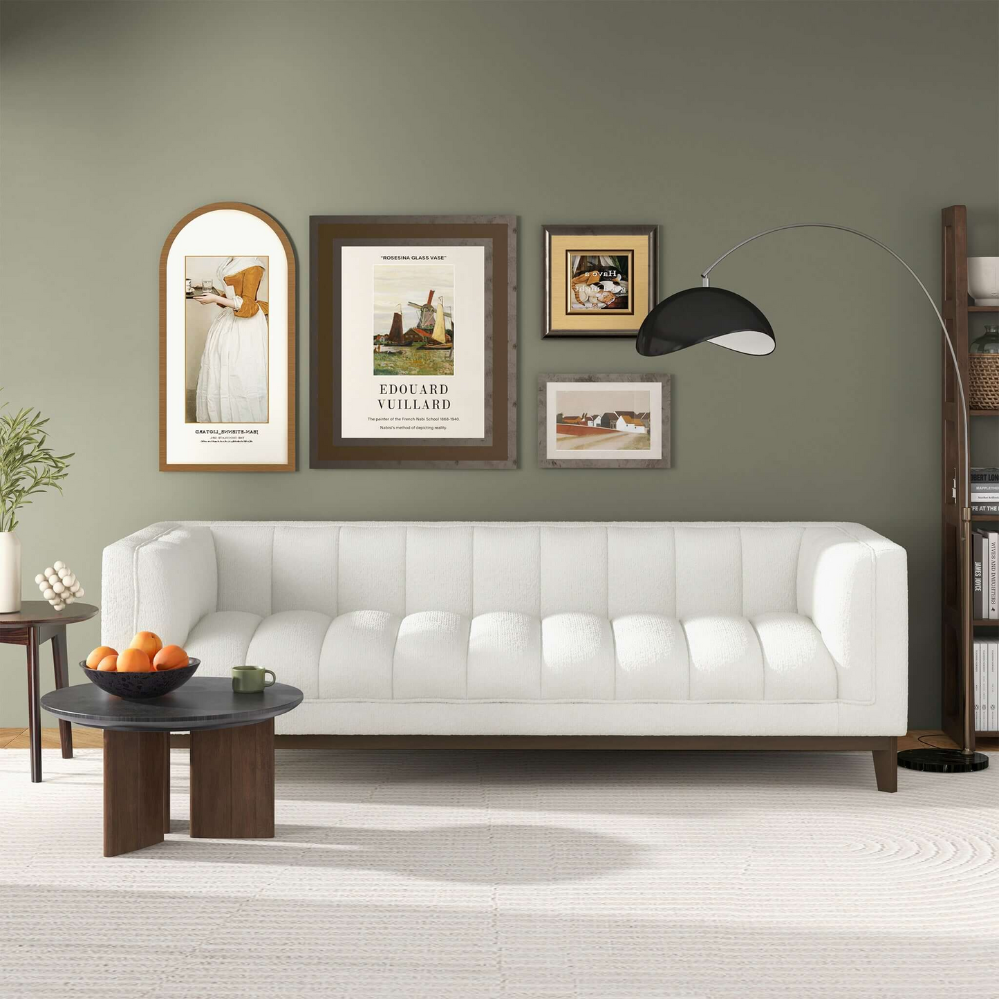 White channeled sofa with wooden legs and accent pillows