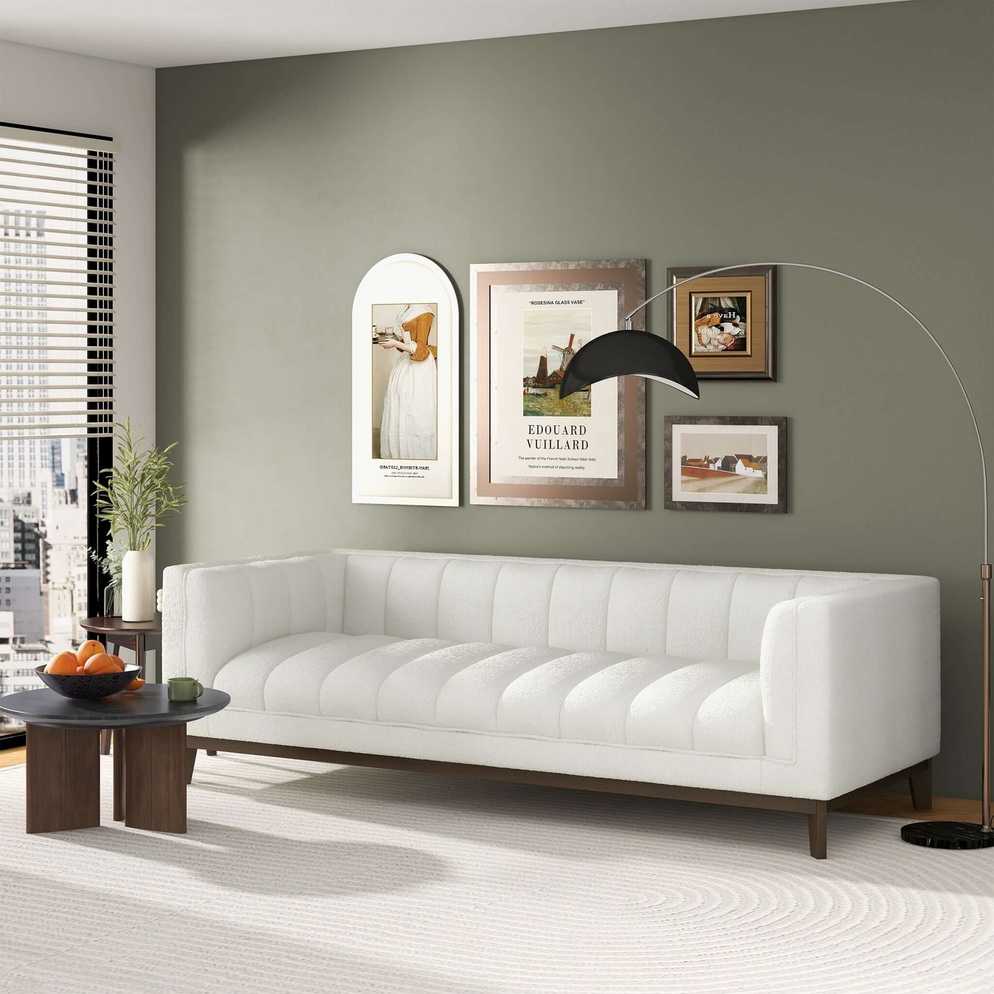 White channeltufted sofa with dark wood legs