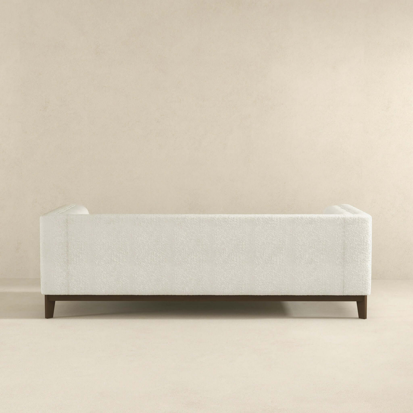 Plush white boucle upholstered sofa with dark wood legs