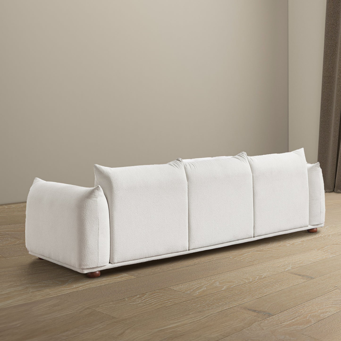 White boucl fabric sectional sofa with plush cushions and wooden legs