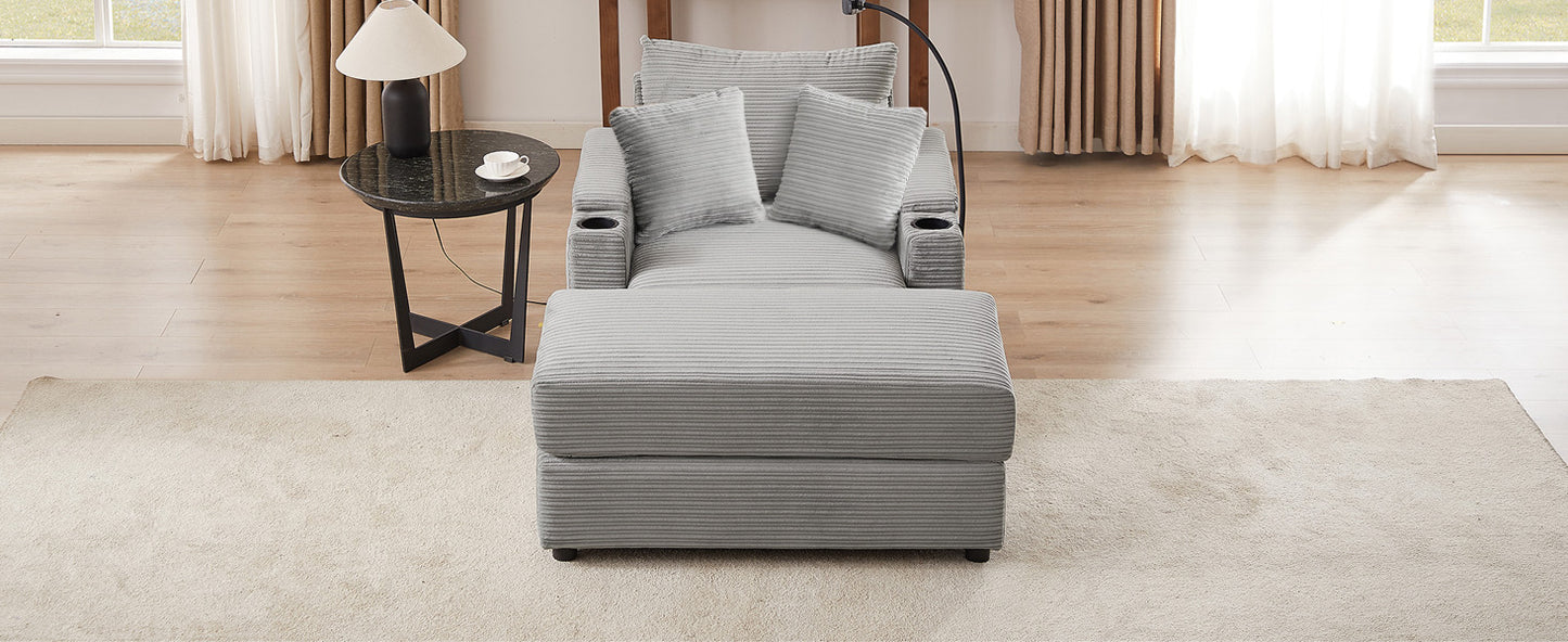 Gray corduroy recliner with plush pillows and builtin cup holders