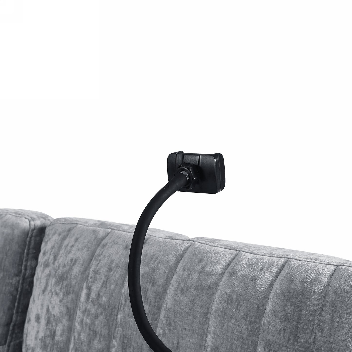 Black flexible gooseneck phone holder clamped to plush grey headboard