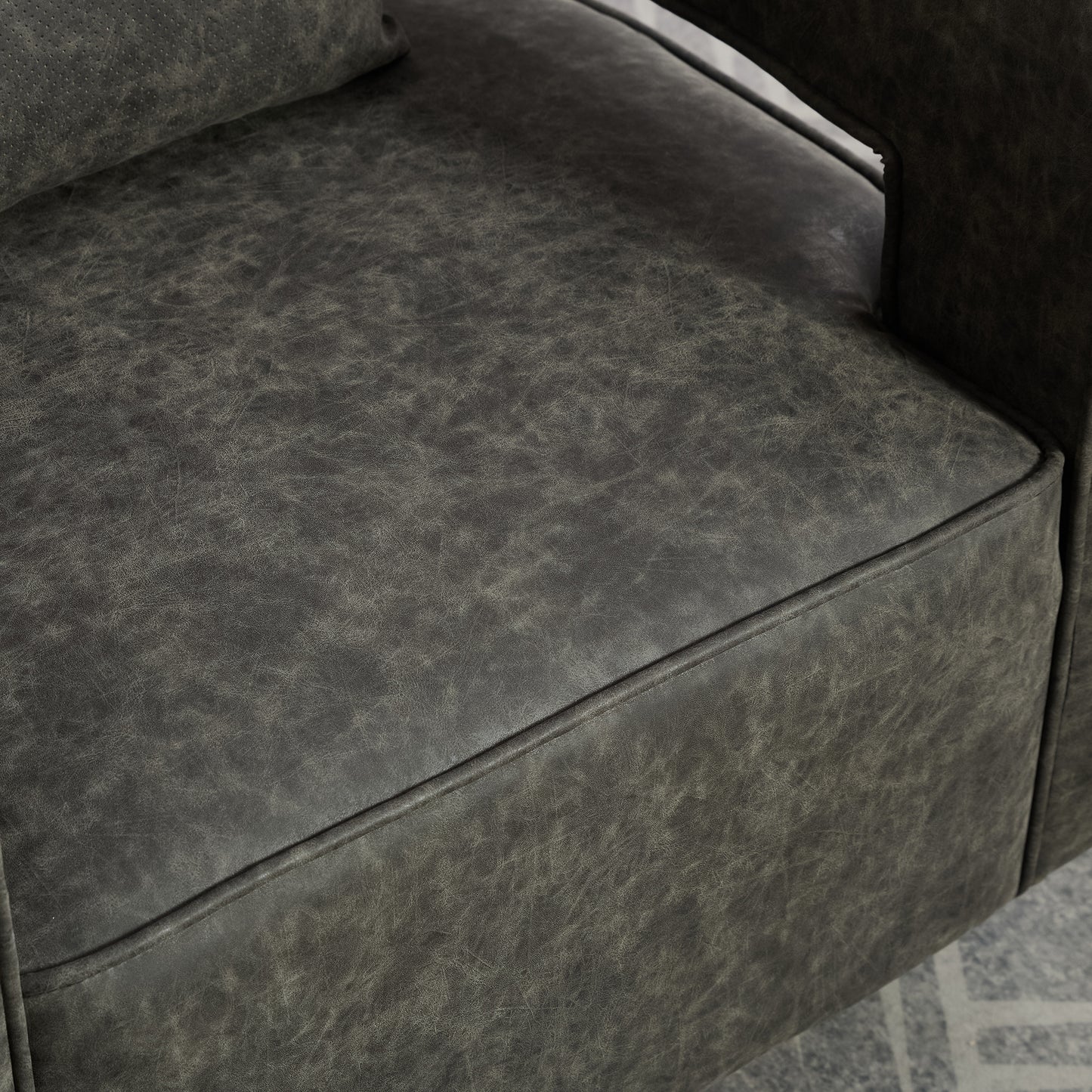 Closeup of distressed charcoal leather upholstery on a recliner