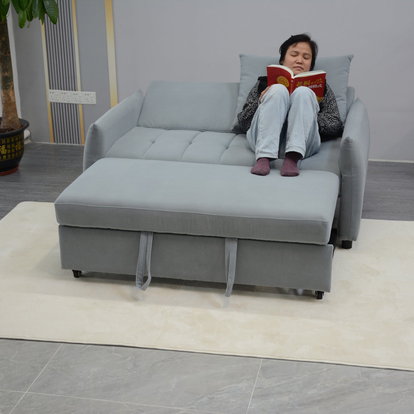 Grey upholstered sleeper sofa with chaise extended