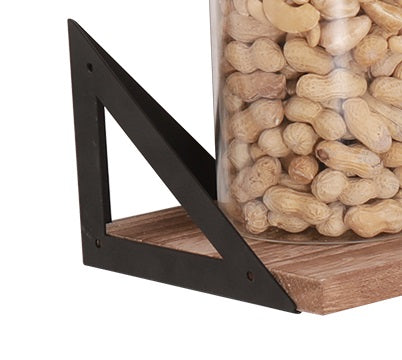 Rustic wall shelf with black metal bracket holding jar of peanuts