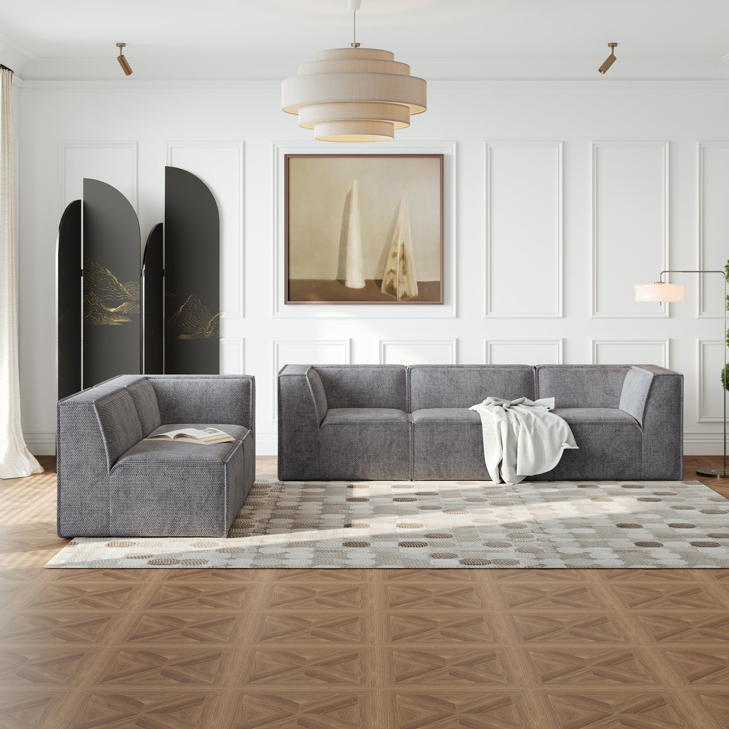 Gray fabric sectional sofa with modern block design and a white throw