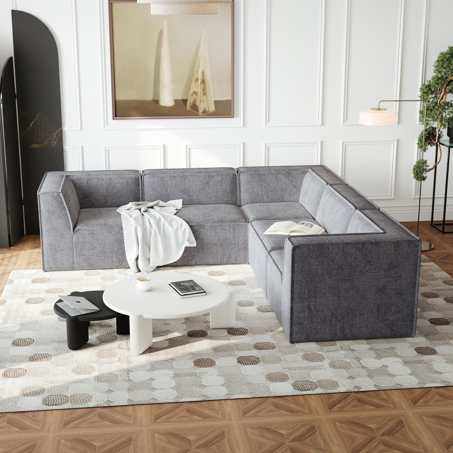 Gray fabric sectional sofa with modern design and white throw blanket