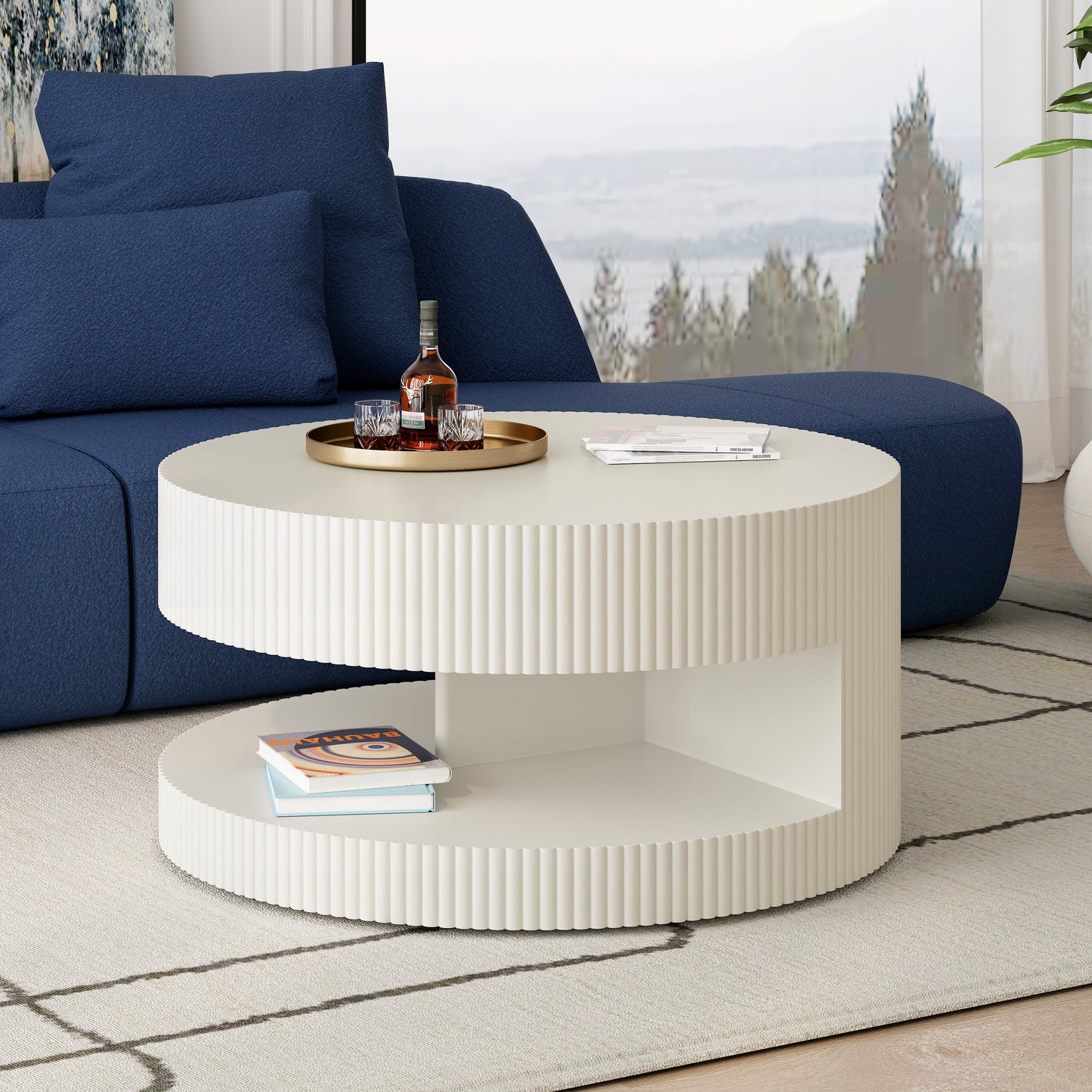White fluted round coffee table with two shelves and a gold tray with whiskey