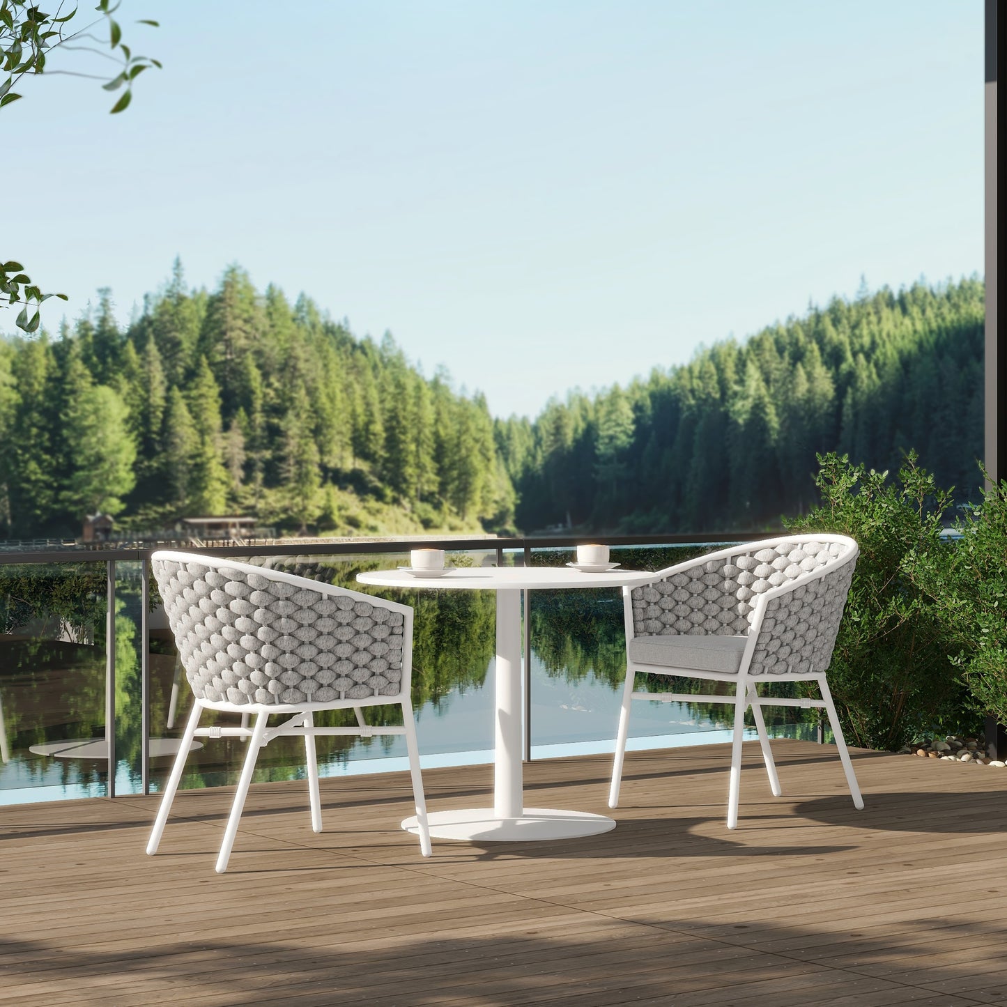 White round bistro table with two grey woven chairs on wooden deck