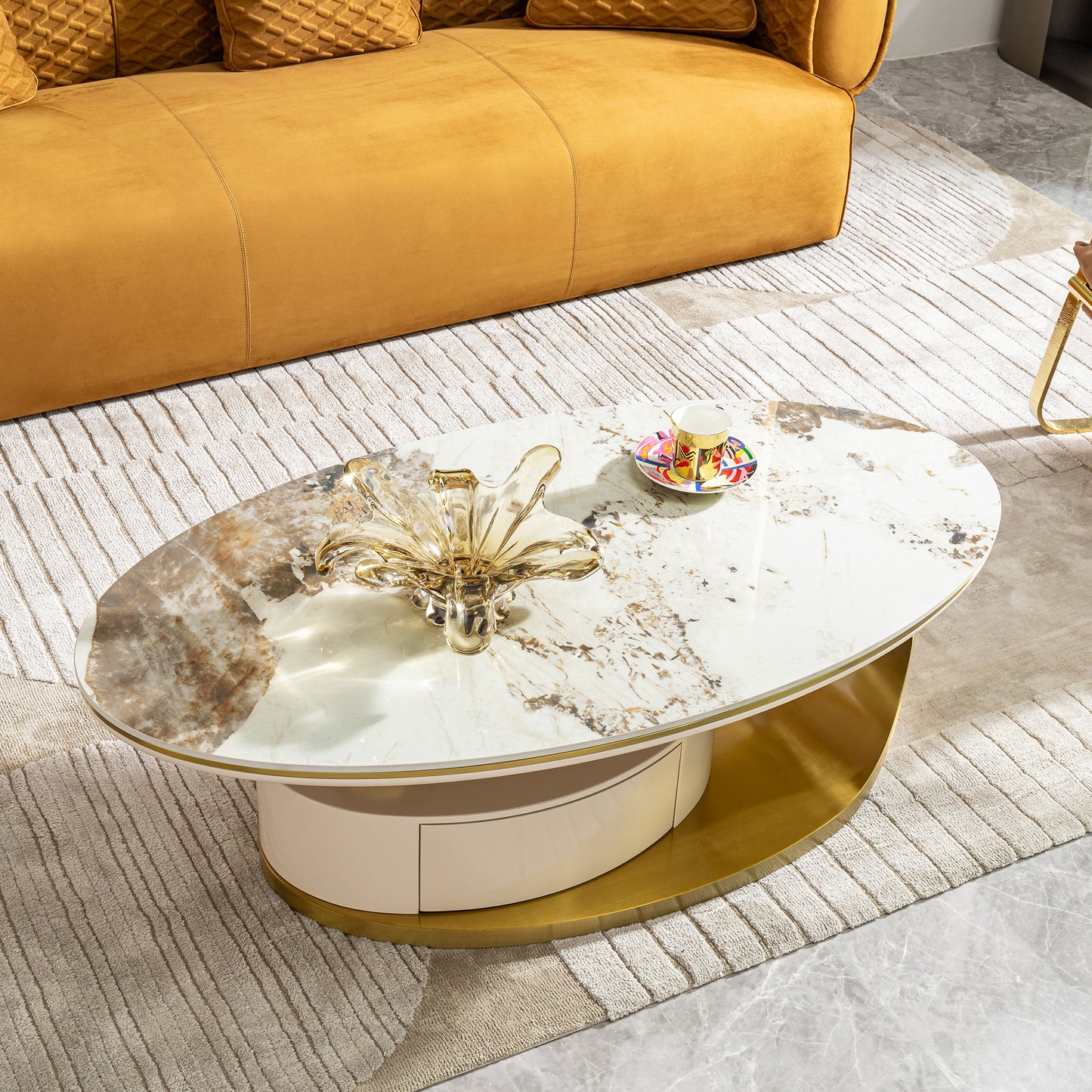 Oval marble coffee table with gold base and cream drawer