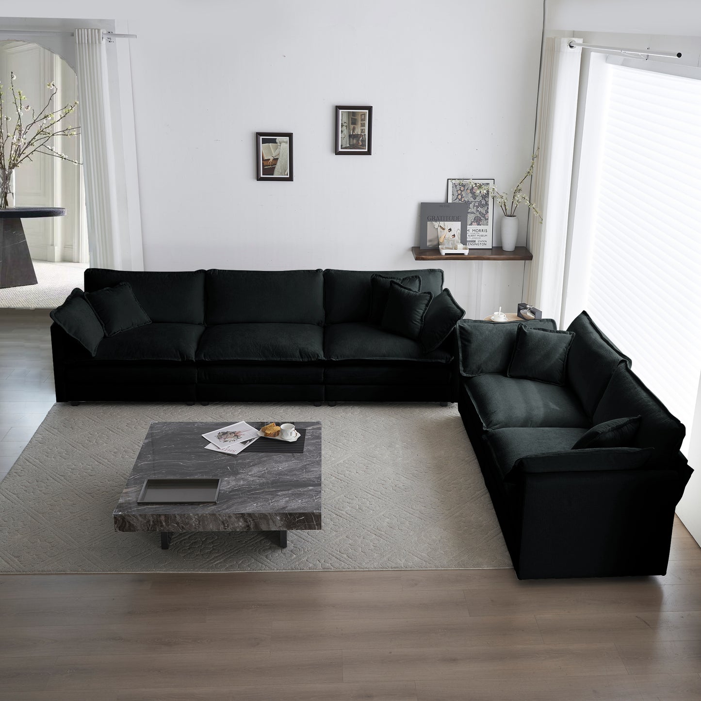 Spacious modular black velvet sofa with plush throw pillows perfect for a modern living room