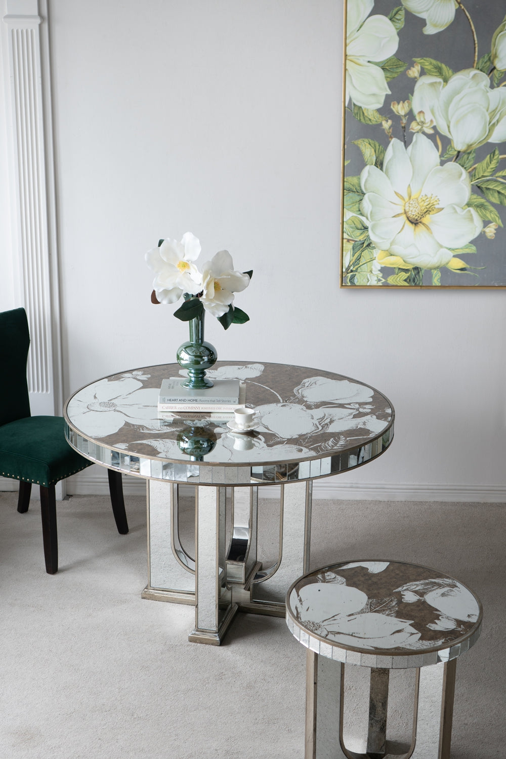 Round mirrored side table with engraved floral design and silver base
