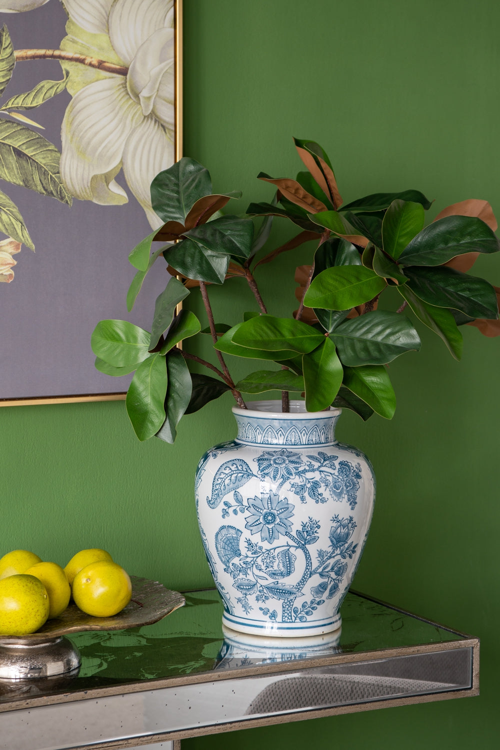 Blue and white porcelain ginger jar with floral pattern holding greenery