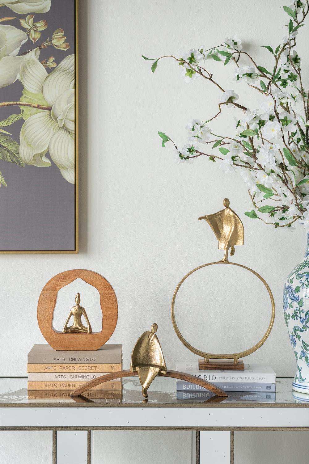 Gold metallic yoga figurine meditating inside a wooden circle frame decor