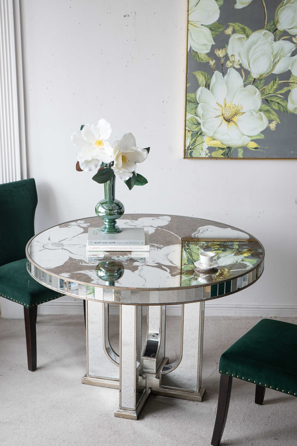 Round mirrored dining table with floral inlay and elegant pedestal base