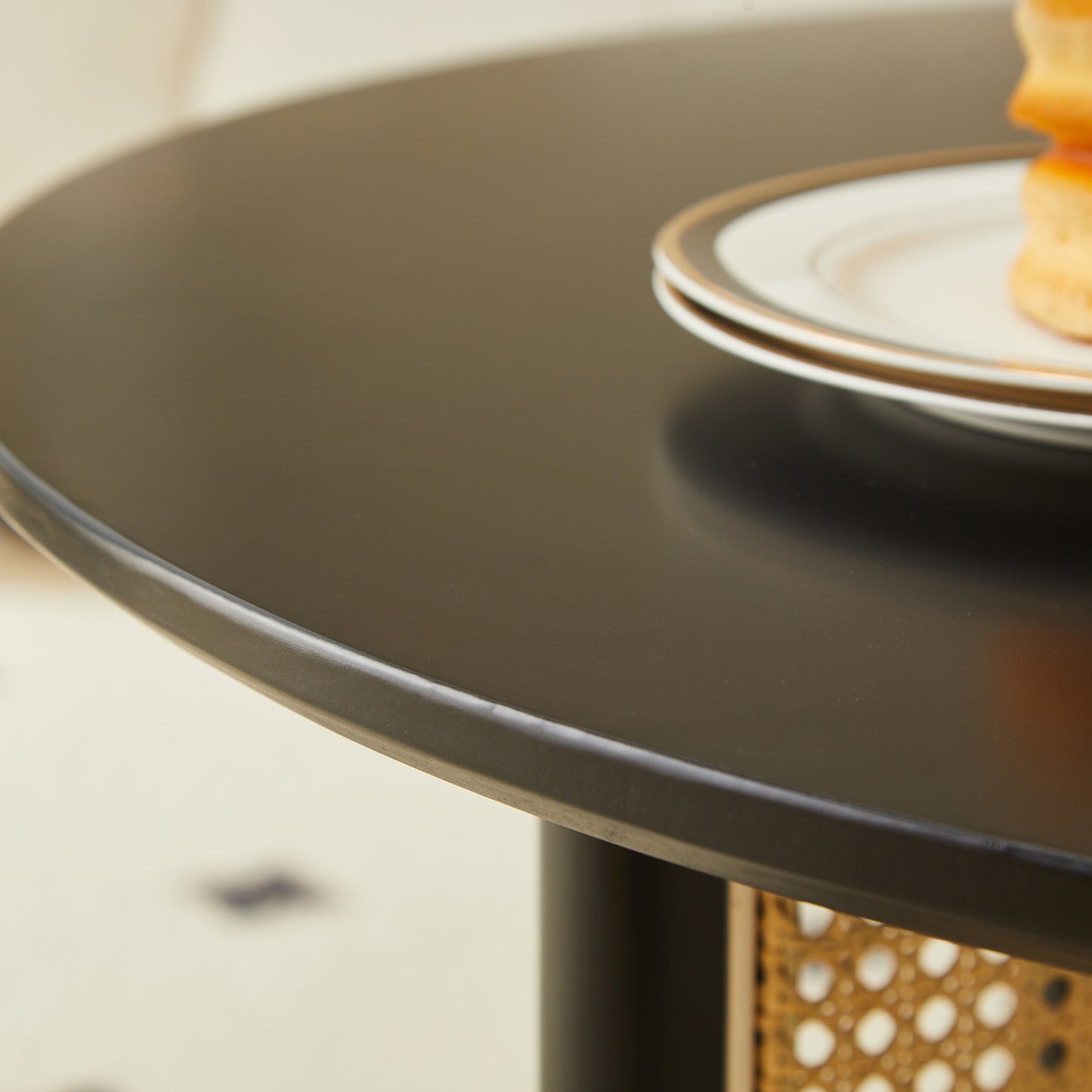 Sleek black round dining table with a modern design perfect for small spaces