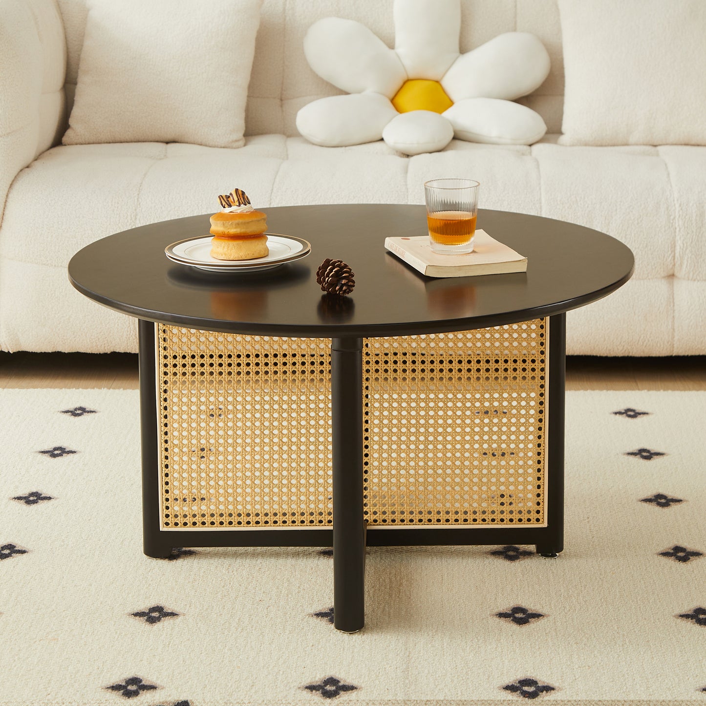 Round black coffee table with woven rattan panels and minimalist design for living rooms